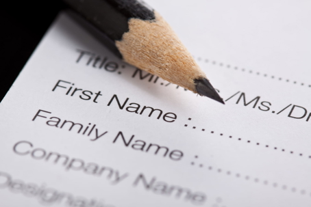 Close-up of a legal form with name fields and a pencil.
